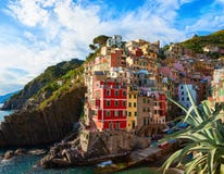 Scenic view of Riomaggiore with its colorful houses at sunset, Cinque Terre National Park, La Spezia, Liguria, Italy royalty free stock photo Scenic view of Riomaggiore with its colorful houses at sunset, Cinque Terre National Park, La Spezia, Liguria, Italy royalty free stock photo