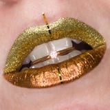 Sch?ne Nahaufnahme mit den weiblichen prallen Lippen mit Goldfarbmake-up Funkelnkosmetik Goldener Ring mit gl?nzendem im Mund lizenzfreie stockfotos Sch?ne Nahaufnahme mit den weiblichen prallen Lippen mit Goldfarbmake-up Funkelnkosmetik Goldener Ring mit gl?nzendem im Mund lizenzfreie stockfotos