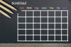 Schedule with grid time table on black chalkboard background stock photo Schedule with grid time table on black chalkboard background stock photo