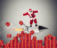 Schnelle Lieferung von den Weihnachtsgeschenken bereit, mit einer Rakete zu fliegen lizenzfreies stockfoto Schnelle Lieferung von den Weihnachtsgeschenken bereit, mit einer Rakete zu fliegen lizenzfreies stockfoto
