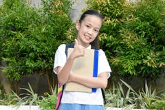 School Girl With Thumbs Up Wearing Uniform With School Books