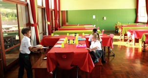 School kids having lunch in canteen stock footage School kids having lunch in canteen stock footage