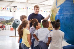 School kids looking at a giant globe at a science centre royalty free stock photo School kids looking at a giant globe at a science centre royalty free stock photo