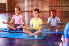 School kids meditating during yoga class
