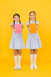 School library. Homeschooling concept. Literacy club. Cute children holding books on yellow background. Little girls