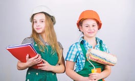 School project. small girls repairing together in workshop. Labor day. 1 may. Little kids in helmet with tablet and royalty free stock image School project. small girls repairing together in workshop. Labor day. 1 may. Little kids in helmet with tablet and royalty free stock image