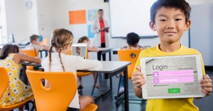 Schoolboy showing log in page on device in classroom royalty free stock photo Schoolboy showing log in page on device in classroom royalty free stock photo
