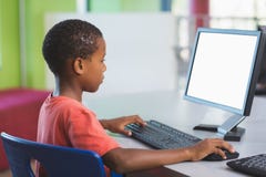 Schoolboy using computer in classroom Royalty Free Stock Photography Schoolboy using computer in classroom Royalty Free Stock Photography