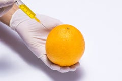 Science experiment with orange and syringe isolated on white. Stock Images Science experiment with orange and syringe isolated on white. Stock Images