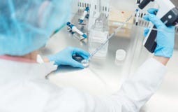 Scientist in lab conducting biotechnological experiment stock images Scientist in lab conducting biotechnological experiment stock images
