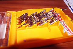 Screw Driver Set on yellow Box.Interchangeable screwdriver set with different types of metal steel heads and bits.set of tools