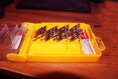 Screw Driver Set on yellow Box.Interchangeable screwdriver set with different types of metal steel heads and bits.set of tools