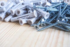 Screws and plastic dowels on wooden background. stock images Screws and plastic dowels on wooden background. stock images