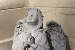 The sculpture of angel with hands joined in silent prayer stock photo The sculpture of angel with hands joined in silent prayer stock photo