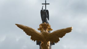 Sculpture of golden two-headed eagle and the angel on the Alexander Column on the Palace Square