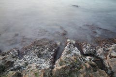 Sea coast in a long exposure shot, with blurred water Royalty Free Stock Images Sea coast in a long exposure shot, with blurred water Royalty Free Stock Images