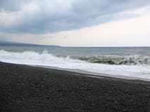 Sea surf and waves crashing against a black sand beach in Bali. royalty free stock photos Sea surf and waves crashing against a black sand beach in Bali. royalty free stock photos