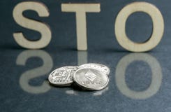 Security Token Offering STO sign with wooden letters and silver coins in front of it, Ethereum concept stock photography Security Token Offering STO sign with wooden letters and silver coins in front of it, Ethereum concept stock photography