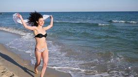 Seductive female with curly hair resting on tropical island, Young beautiful girl running along beach, happy woman stock footage Seductive female with curly hair resting on tropical island, Young beautiful girl running along beach, happy woman stock footage