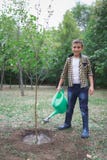 Hand nurturing and watering a young plant, Love and protect nature concept, nurturing a baby plant. Watering tree, earth stock photo Hand nurturing and watering a young plant, Love and protect nature concept, nurturing a baby plant. Watering tree, earth stock photo