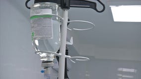 Abdominal liposuction. Selective focus Infusion bottle with IV solution in the patient room