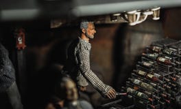 Selective Focus Photography of Male Doll Holding Bottle Near Bottle Rack Royalty Free Stock Image Selective Focus Photography of Male Doll Holding Bottle Near Bottle Rack Royalty Free Stock Image
