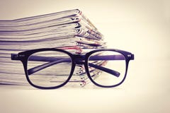 Selective focus on reading eyeglasses with stacking of newspaper royalty free stock photo Selective focus on reading eyeglasses with stacking of newspaper royalty free stock photo