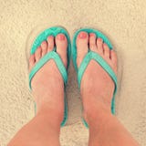 Selfie of woman feet wearing flip flops on a beach stock photography Selfie of woman feet wearing flip flops on a beach stock photography