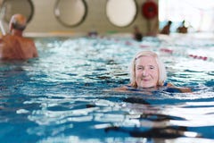 Senior active lady swims in the pool stock photography Senior active lady swims in the pool stock photography