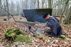 Senior active man camping in woods with yerba drink