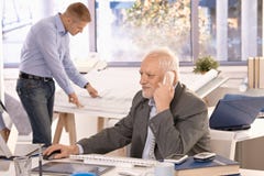 Senior businessman and young architect working Royalty Free Stock Photography Senior businessman and young architect working Royalty Free Stock Photography