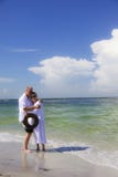 Senior couple embrace on beach