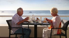 Senior couple have breakfast at the hotel outdoor