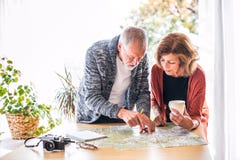 Senior couple with map at home, making plans. Royalty Free Stock Photo Senior couple with map at home, making plans. Royalty Free Stock Photo