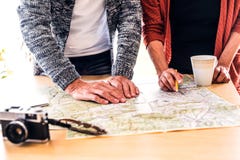 Senior couple with map at home, making plans. Royalty Free Stock Photos Senior couple with map at home, making plans. Royalty Free Stock Photos