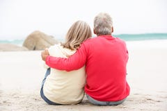 Senior Couple On Holiday Sitting On Winter Beach Stock Image Senior Couple On Holiday Sitting On Winter Beach Stock Image