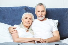 Senior couple sitting on the bed stock image Senior couple sitting on the bed stock image