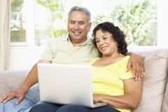 Senior Couple Using Laptop At Home royalty free stock photography Senior Couple Using Laptop At Home royalty free stock photography