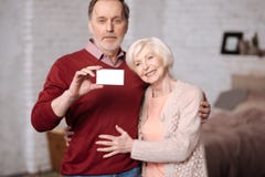Senior family stading with insuarence card Royalty Free Stock Images Senior family stading with insuarence card Royalty Free Stock Images