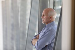 Senior grey-haired man standing deep in thought royalty free stock photos Senior grey-haired man standing deep in thought royalty free stock photos