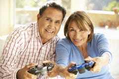 Senior Hispanic Couple Playing Video Game At Home royalty free stock images Senior Hispanic Couple Playing Video Game At Home royalty free stock images