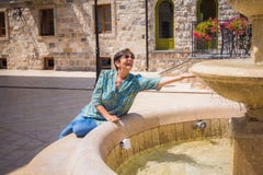 Senior lady on the fountain stock images Senior lady on the fountain stock images