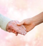 Senior Lady Holding Hands with Young Woman royalty free stock photo Senior Lady Holding Hands with Young Woman royalty free stock photo