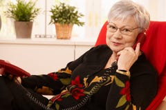 Senior lady using landline phone