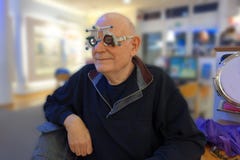 Senior at the optician testing new lenses in a trail frame royalty free stock photo Senior at the optician testing new lenses in a trail frame royalty free stock photo