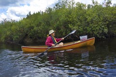 Senior man paddling a small canoe on the Moose River. Stock Photography Senior man paddling a small canoe on the Moose River. Stock Photography
