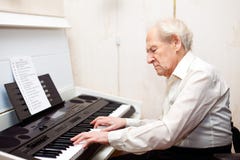 Senior Man Playing Piano stock photo Senior Man Playing Piano stock photo