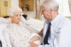 Senior Man Sitting With His Wife In Hospital stock image Senior Man Sitting With His Wife In Hospital stock image
