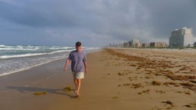 Senior man walking on beach Stock Photo Senior man walking on beach Stock Photo