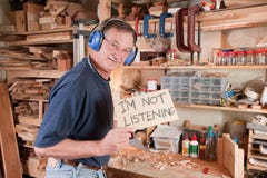 Senior man in workshop not listening Royalty Free Stock Photography Senior man in workshop not listening Royalty Free Stock Photography